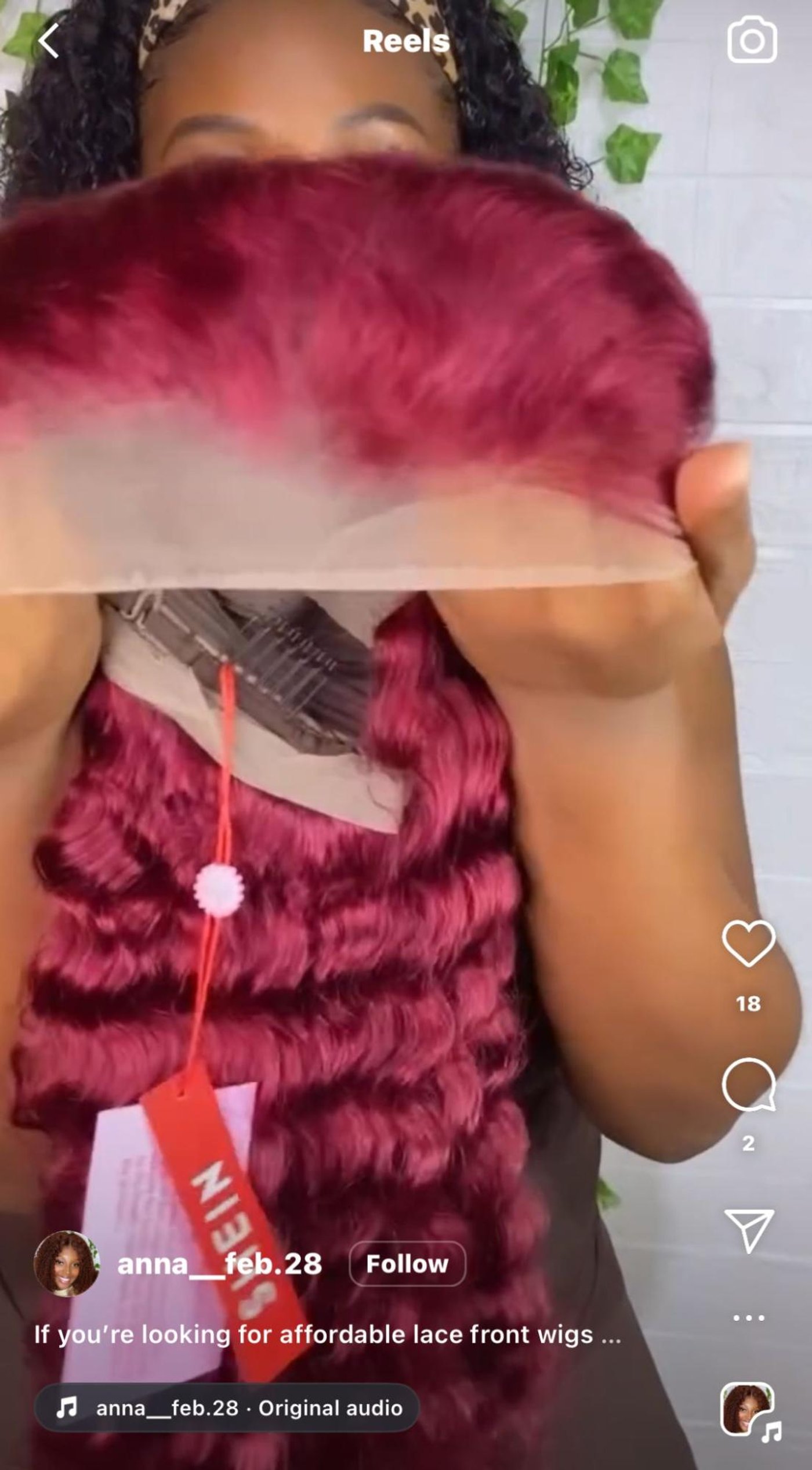 Person showcasing a vibrant red lace front wig with wavy texture in a video. Channel: anna__feb.28