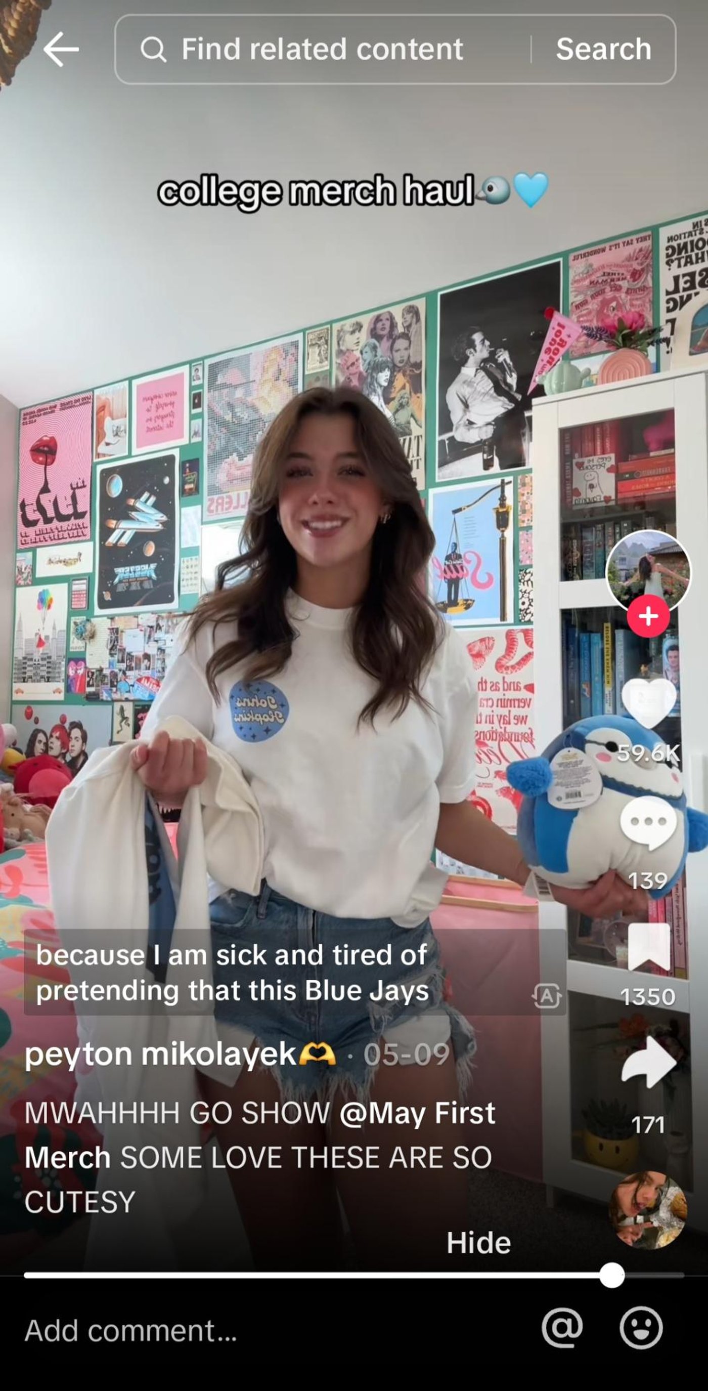 Peyton mikolayek shares her college merch haul, holding a plushie and sweatshirt, smiling.