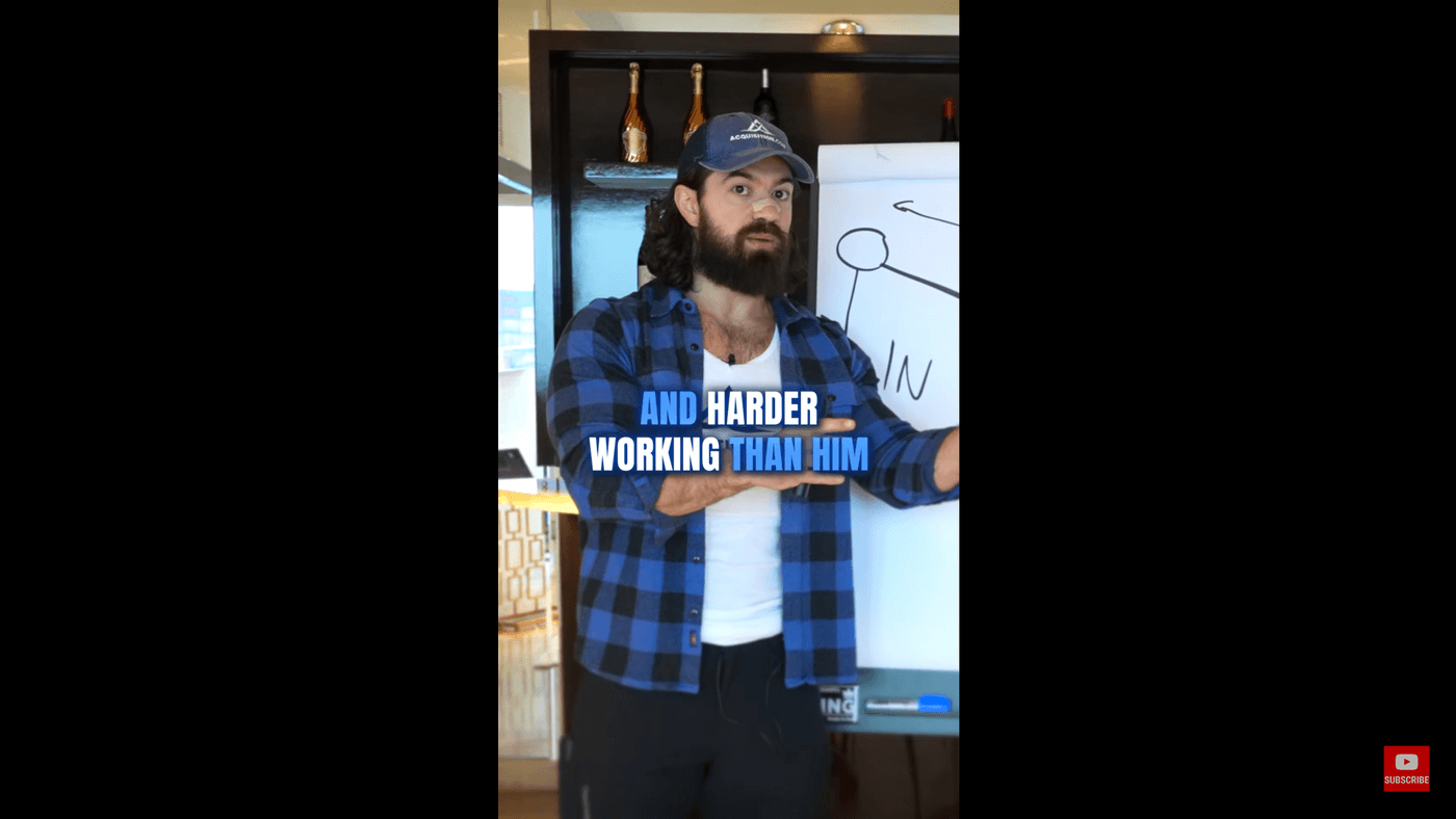 The man in blue shirt speaking with subtitles 'and harder working than him.