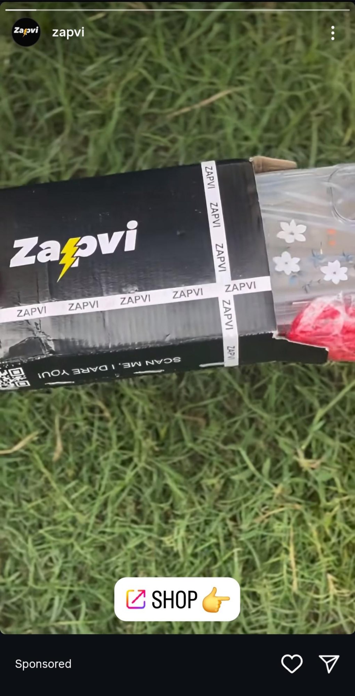Zapvi sponsored ad showing branded black packaging with logo and “Shop” button over a grassy background.