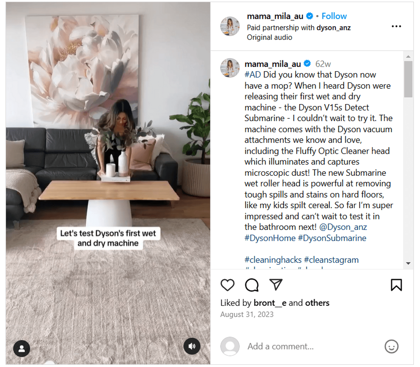Woman demonstrating Dyson’s first wet and dry vacuum machine in modern living room setting